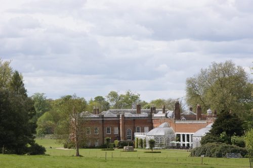 Avington House Hampshire, a grand red brick country estate surrounded by lawns and mature trees, representing trusted house sitting Hampshire