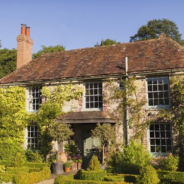 An ivy-covered country house in Haslemere Surrey surrounded by gardens, representing trusted house sitting Surrey
