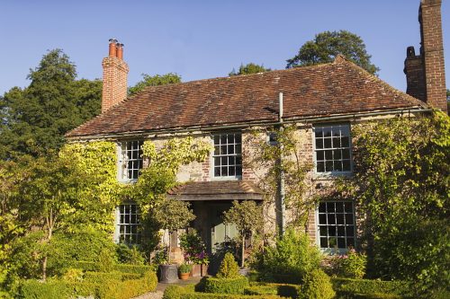 An ivy-covered country house in Haslemere Surrey surrounded by gardens, representing trusted house sitting Surrey