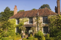 An ivy-covered country house in Haslemere Surrey surrounded by gardens, representing trusted house sitting Surrey